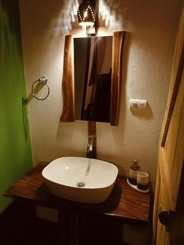 a bathroom with a white sink and a mirror at Isla Bonita in Cambutal