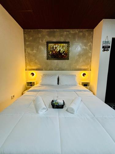 a large white bed with a camera on it at Hospedagem Marechal 02 in São Roque