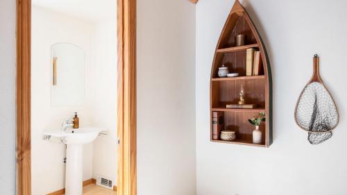 a bathroom with a mirror and a sink at Hartwood by AvantStay Cozy Big Bear Abode w Spacious Deck Stone Fireplace in Big Bear Lake