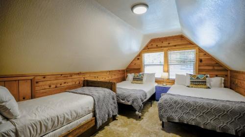 a attic room with two beds and a window at Aster by AvantStay Classic Kings Beach Cottage In The Of North Shore in Kings Beach