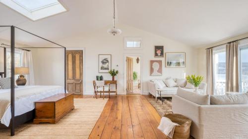 a bedroom with a bed and a living room at River House by AvantStay Historic Secluded Estate on the Hudson River w Pool Sleeps 24 in Hudson