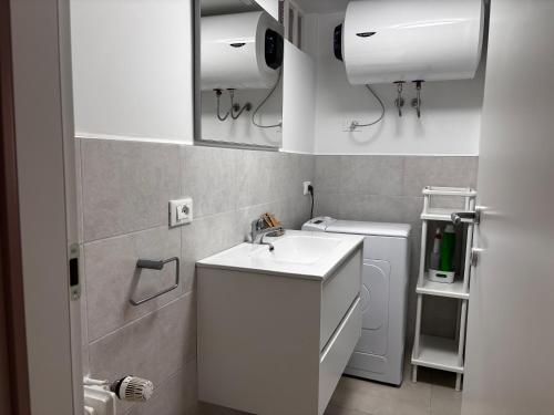 a white bathroom with a sink and a toilet at Matterhorn Studio Cervinia in Breuil-Cervinia