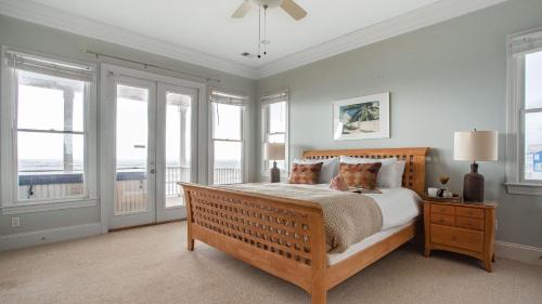 a bedroom with a bed with a view of the ocean at Poseidon By AvantStay On The Beach Two Ocean Facing Balconies Hot Tub in Folly Beach