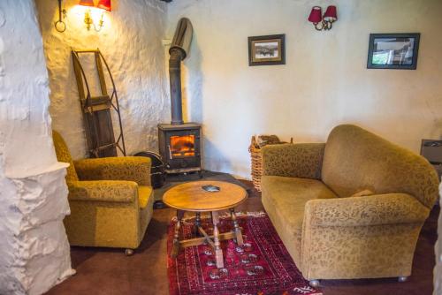 a living room with two couches and a wood stove at The Cuckoo Brow Inn in Far Sawrey