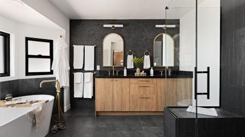 a bathroom with a tub and a sink and mirrors at Roca Roja by AvantStay Mountain Views in the Heart of Sedona in Sedona