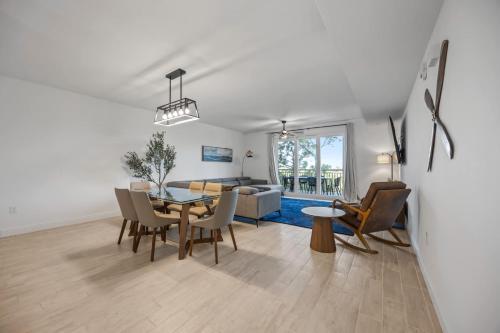 a dining room and living room with a table and chairs at Luxury Condo with Sanctuary Views Merritt Island in Audubon