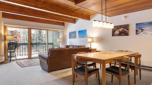 a dining room with a table and a couch at Riverside Condos D01 by AvantStay Condo Close To Downtown Town Park Ski Lift 8 in Telluride