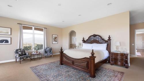 a bedroom with a large bed and a large window at Palazzo Del Sol By AvantStay Breathtaking Home w Mountain Views Hot Tub in Temecula