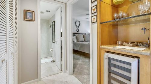 a bathroom with a sink and a bathroom with a bed at Dune Wind South by AvantStay Communal Pool Hot Tub Gated Community Close to Smathers Beach Month Long Stays Only in Key West