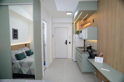 a kitchen with a sink and a bed in a room at Green One - Em Frente à Estação Luz com vaga rotativa in Sao Paulo