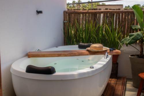 Fotografie z fotogalerie ubytování Nomad Palmeira Duplex com Hidromassagem privativa v destinaci Pôrto de Pedras