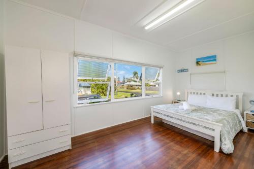 Ένα ή περισσότερα κρεβάτια σε δωμάτιο στο The Cottage 16 Clarke Street Bargara