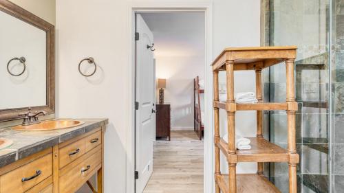a bathroom with a wooden ladder next to a sink at Honeypot by AvantStay Indoor Pool Hot Tub in Big Bear Lake