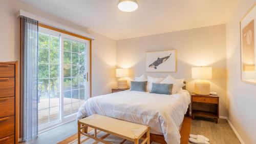 a bedroom with a bed and a large window at Whidbey Bliss by AvantStay 2min to Beach View in Greenbank