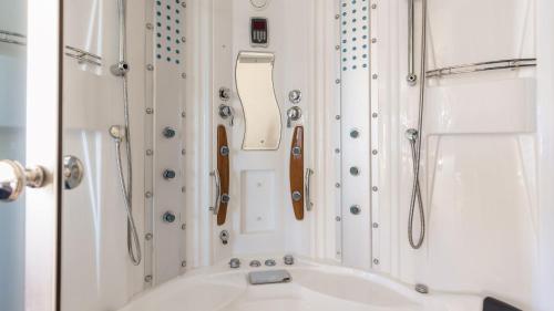 a bathroom with a white tub and a sink at Paddington by AvantStay Cozy Chic Ski Lodge Mins from Mountain in Breckenridge