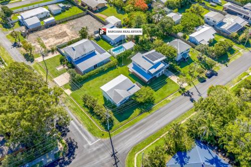 an aerial view of a suburb with houses at The Beach House 16 Clarke Street Bargara in Bargara