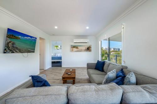 a living room with a couch and a table at The Beach House 16 Clarke Street Bargara in Bargara
