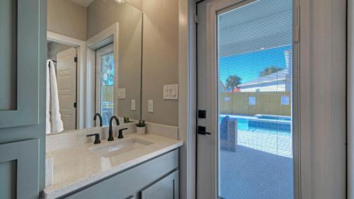a bathroom with a sink and a mirror at Private PoolHot Tub Near the Beach Gulf Glimpse Marlin Cove by AvantStay in Port Aransas