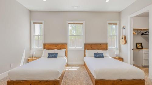 two beds in a room with two windows at Cooperage by AvantStay Vineyard Views Soccer in Templeton
