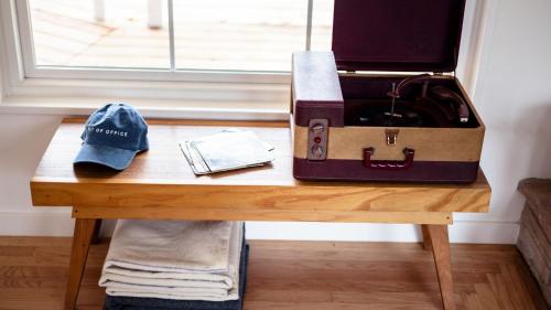 a table with a suitcase and a hat on it at Marquee By AvantStay Modern Stylish Estate w Pool Entertainers Courtyard in Boyes Hot Springs