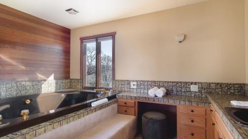a bathroom with a large tub and a sink at Gable by AvantStay Beautiful 3.5 Acre Oasis w Gorgeous Views Pool Hot Tub in Santa Rosa