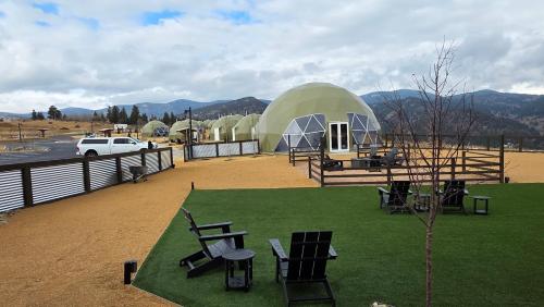 a large dome house with a table and chairs on a field at The Nest at Black Hawk in Black Hawk