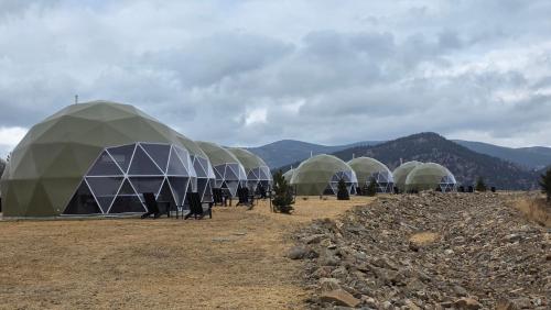 a group of domes with people standing in front of them at The Nest at Black Hawk in Black Hawk