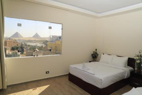 Ένα ή περισσότερα κρεβάτια σε δωμάτιο στο Jewel pyramids & Grand museum view
