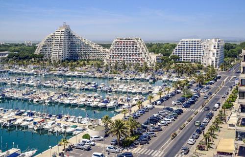 an aerial view of a marina with boats and buildings at Mercure Port La Grande Motte in La Grande-Motte