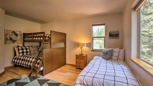 a bedroom with bunk beds and a bed and a window at Moosetrack by AvantStay Cozy Cabin w Hot Tub In The Heart of Tahoe Donner in Truckee
