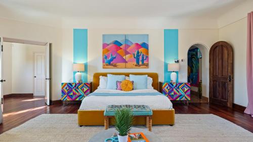 a bedroom with a large bed and two tables at Luxe 7BDR Oasis w Pool Putting Green Game Room Villa Del Gallo by AvantStay in Bermuda Dunes