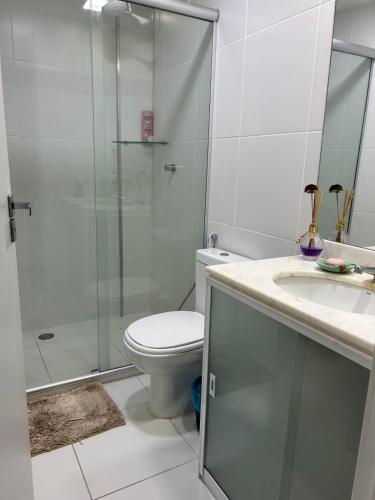 a bathroom with a shower and a toilet and a sink at In mare Bali Resort in Parnamirim