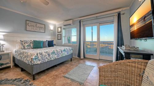 a bedroom with a bed and a large window at Studio w Balcony Pools Direct Beach Access Seaside Blessing by AvantStay in Port Aransas