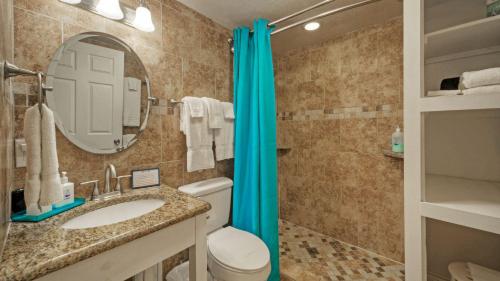 a bathroom with a toilet and a sink and a mirror at Studio w Balcony Pools Direct Beach Access Seaside Blessing by AvantStay in Port Aransas