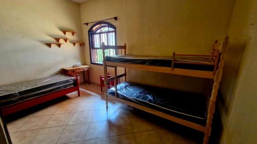 En eller flere senge i et værelse på Casa de Praia Itanhaem