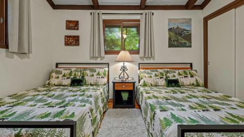 a bedroom with two beds and a window at The Four Seasonal by AvantStay Hot Tub Spacious Deck Fire Pit in Pocono Pines