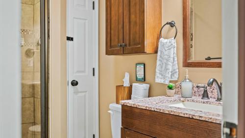 a bathroom with a sink and a toilet at The Four Seasonal by AvantStay Hot Tub Spacious Deck Fire Pit in Pocono Pines