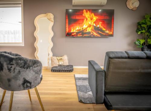 a living room with a couch and a fireplace at Hobart Family Retreat with Spa and Backyard Near Airport in Sorell