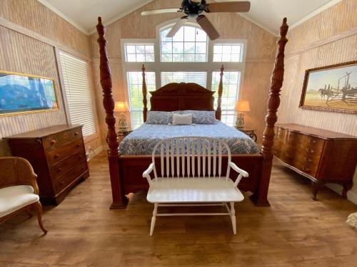 a bedroom with a bed and a white chair at Agave Point in Concan
