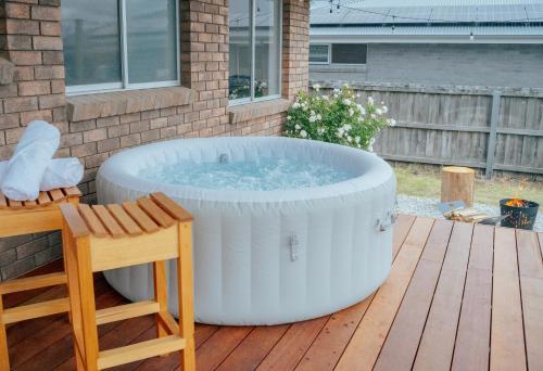 a large hot tub sitting on a deck at Hobart Family Retreat with Spa and Backyard Near Airport in Sorell