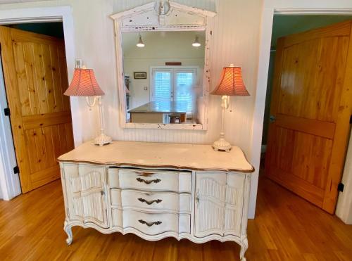 a dressing table with two lamps and a mirror at Agave Point in Concan