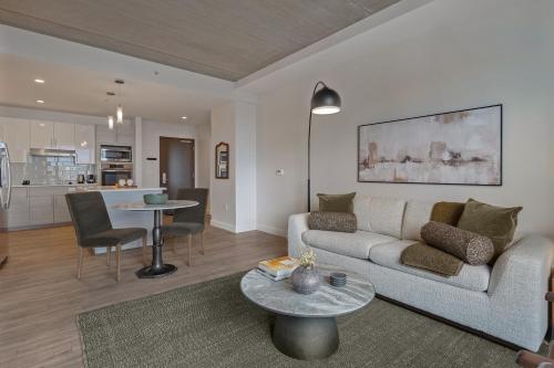 a living room with a couch and a table at Hyatus Luxury Residences Boston Assembly Row in Somerville