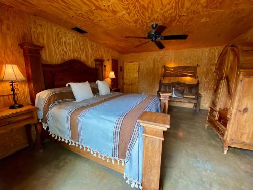 a bedroom with a bed and a ceiling fan at Agua Bonita in Concan