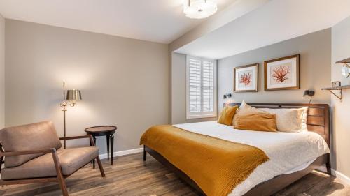 a bedroom with a bed and a chair at Harrington Hideaway by AvantStay Beach Access in Coupeville