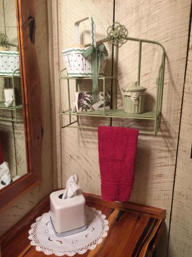 a table with a candle and a towel and shelves at La Casita in Concan