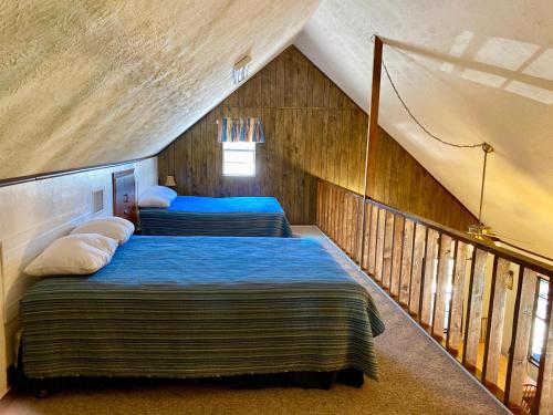 a bedroom with two beds in a attic at Rusty Rio in Concan