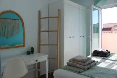 a bedroom with a bed and a desk and a window at Villa Domicil de Luxe in Torrevieja