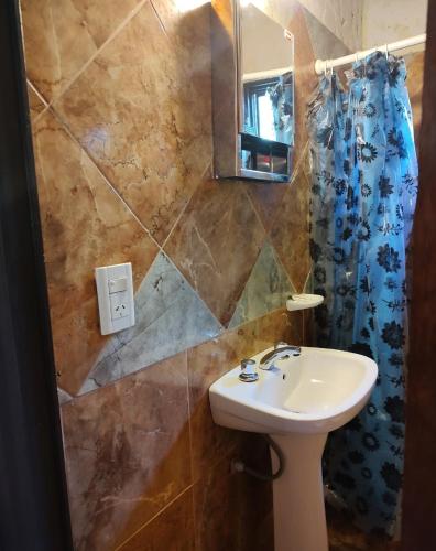 a bathroom with a sink and a mirror at Rincón Soñado in Las Rabonas