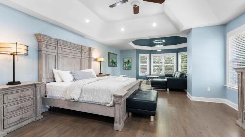 a bedroom with a large bed and blue walls at Laid Back Lake Life by AvantStay Waterfront View in Mooresville