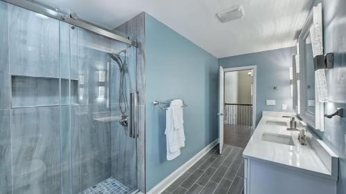 a bathroom with two sinks and a shower at Laid Back Lake Life by AvantStay Waterfront View in Mooresville